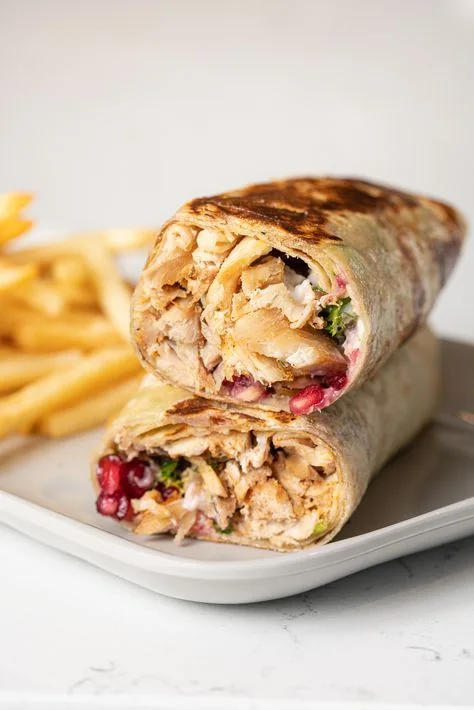 Sliced grilled wrap with fries